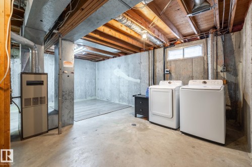 Unfinished basement with concrete flooring and exposed ceiling joists - #20 3812 20 Av Nw, Edmonton, AB 