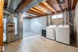 Unfinished basement with concrete flooring and exposed ceiling joists - 