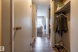Hallway featuring wood-finish flooring extending into the background - 