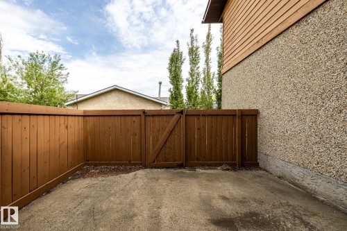 Private yard space featuring a wood fence, gate, and concrete pad - #20 3812 20 Av Nw, Edmonton, AB 