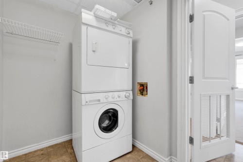 Stackable washer and dryer, wire shelving, and wood-finish flooring - #215 9820 165 St Nw, Edmonton, AB 