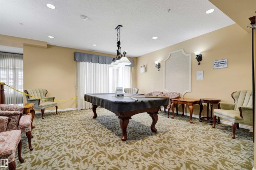 Recreational room featuring a billiard table, recessed lighting, wall sconces, and patterned carpeting - #215 9820 165 St Nw, Edmonton, AB 