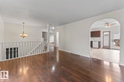 Rich wood-finish flooring extends through this open living space - 