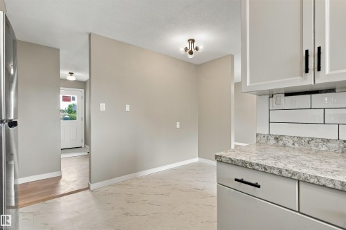 Neutral wall tones, recessed window, dark-finish ceiling fan, and carpeted flooring - 9908 99 Street, Morinville, AB 