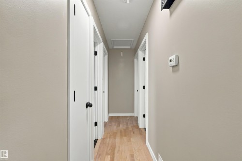 Neutral wall paint, plush carpet flooring, built-in closet, ceiling fan with light, and white trim - 9908 99 Street, Morinville, AB 