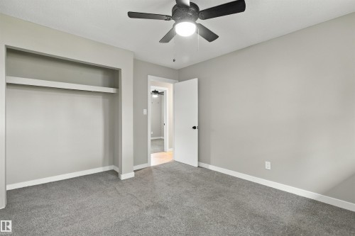 Hardwood flooring, painted walls, white trim, recessed light, and a modern chandelier - 9908 99 Street, Morinville, AB 