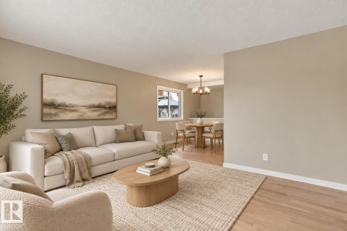 Open-concept living area featuring light-toned walls, recessed lighting, and wood-finish flooring - 9908 99 Street, Morinville, AB 
