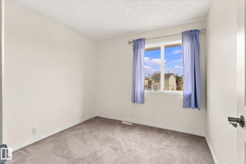 Light gray carpet flooring complementing light-toned walls - #3 18010 98 Av Nw, Edmonton, AB 