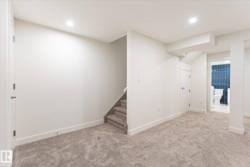 Spacious room featuring neutral carpeting and recessed lighting - #3 18010 98 Av Nw, Edmonton, AB 