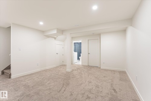 Carpeted room with recessed lighting, white walls, and white trim - #3 18010 98 Av Nw, Edmonton, AB 