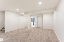 Carpeted room with recessed lighting, white walls, and white trim - 