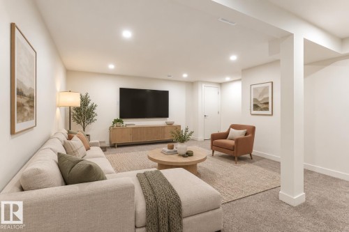 Recessed lighting, wood-finish media console, neutral wall color, white trim, and carpeted flooring - #3 18010 98 Av Nw, Edmonton, AB 