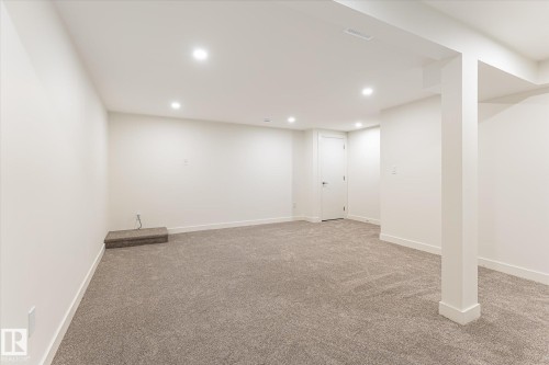 Recessed ceiling lighting, light-toned carpeting, white painted walls, white trim, and a white door - #3 18010 98 Av Nw, Edmonton, AB 