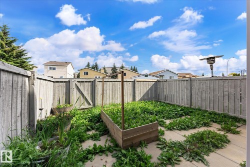 Raised garden bed, wood panel fencing, and concrete patio area - #3 18010 98 Av Nw, Edmonton, AB 