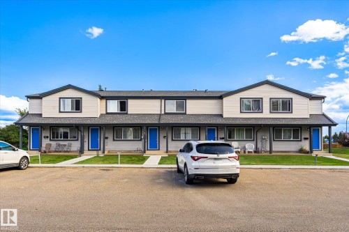 Two-story townhome residences featuring gabled rooflines and covered entryways - #3 18010 98 Av Nw, Edmonton, AB 