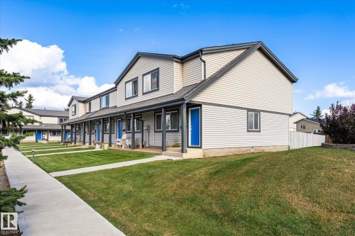Exterior siding construction, two-story structure, gabled roofline, individual entry doors, and a concrete walkway - #3 18010 98 Av Nw, Edmonton, AB 