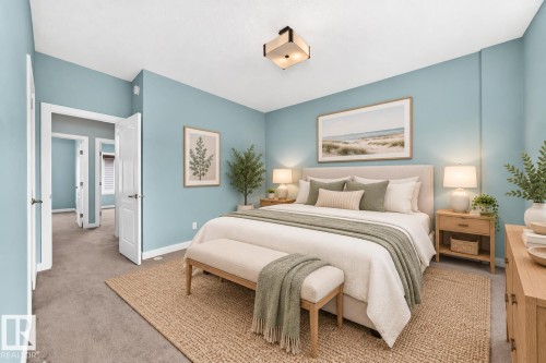 Recessed ceilings, neutral carpet flooring, light blue wall paint, white trim, and a contemporary flush mount light fixture - #56 804 Welsh Dr Sw, Edmonton, AB 