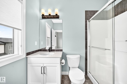 Single vanity with white cabinetry, quartz countertop, and undermount sink - #56 804 Welsh Dr Sw, Edmonton, AB 