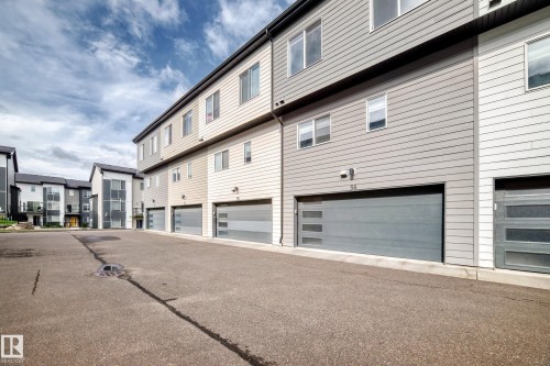 Modern multi-story facade featuring horizontal siding in varied neutral tones - #56 804 Welsh Dr Sw, Edmonton, AB 