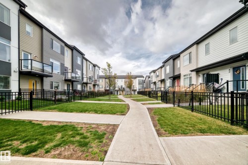 Modern townhome development featuring multiple units with individual balconies and dedicated entryways - #56 804 Welsh Dr Sw, Edmonton, AB 