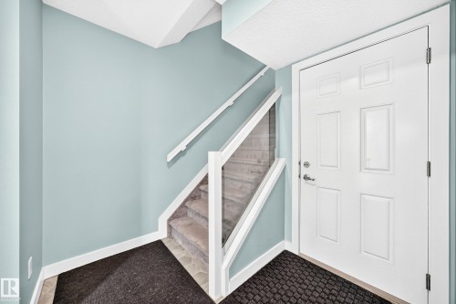 Glass panel railing with white wood-finish handrail - #56 804 Welsh Dr Sw, Edmonton, AB 