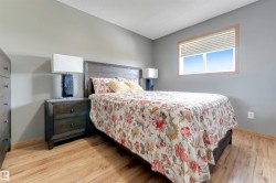 Wood-finish flooring with a neutral wall color, complemented by a window with natural wood trim - 