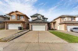 Two-story residence with a two-car garage, concrete driveway, and a front entrance featuring a covered porch - 