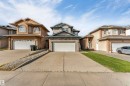 Two-story residence with a two-car garage, concrete driveway, and a front entrance featuring a covered porch - 4510 164A Ave Nw, Edmonton, AB 