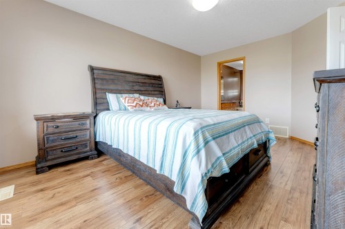 Wood-finish flooring throughout, neutral wall tones, and recessed lighting - 4510 164A Ave Nw, Edmonton, AB 