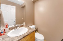 Vanity with an oval undermount sink, chrome faucet, and composite countertop - 
