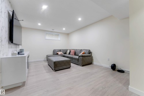 Recessed lighting, wood-finish flooring, and a window with horizontal blinds - 4510 164A Ave Nw, Edmonton, AB 