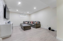 Recessed lighting, wood-finish flooring, and a window with horizontal blinds - 