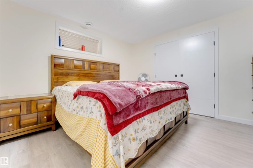 Wood-finish flooring, white walls, and a window with blinds - 4510 164A Ave Nw, Edmonton, AB 