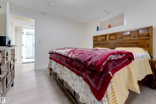 Wood-finish flooring, recessed lighting, and a window with blinds - 4510 164A Ave Nw, Edmonton, AB 