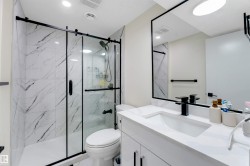 White vanity with an integrated sink and black faucet - 