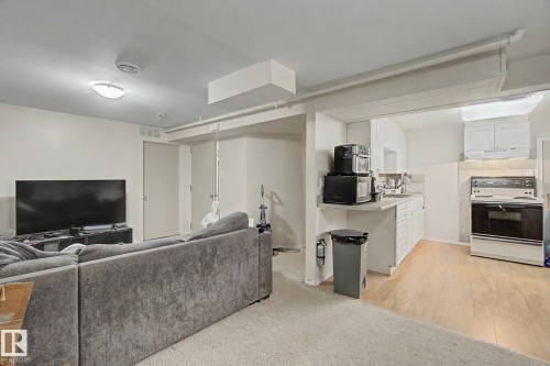 Open concept area featuring a kitchen and living space - 8710 83 Avenue Nw, Edmonton, AB - Indoor