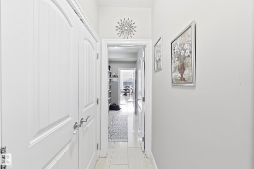 White paneled doors with brushed nickel hardware, light tile flooring, and white wall finishes - 144 52 Street Sw, Edmonton, AB 