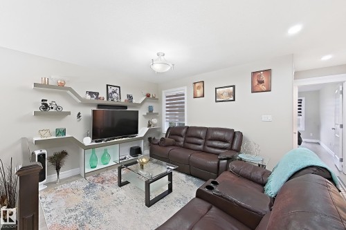 Recessed lighting, wood-finish flooring, and a contemporary light fixture - 144 52 Street Sw, Edmonton, AB 