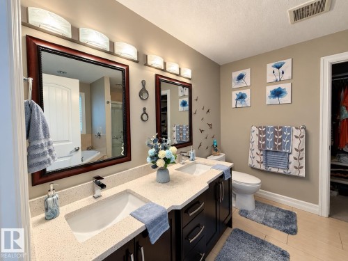 Dual vanity with integrated sinks and chrome faucets - 144 52 Street Sw, Edmonton, AB 