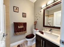 Dark wood-finish vanity with a light-toned countertop and integrated sink - 