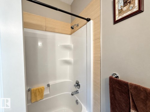 White tub and shower combination with chrome fixtures - 144 52 Street Sw, Edmonton, AB 