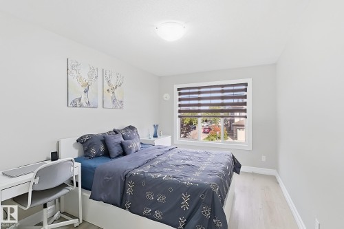 Light-toned walls with a single window featuring horizontal blinds - 144 52 Street Sw, Edmonton, AB 