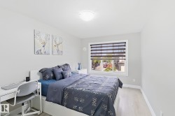 Light-toned walls with a single window featuring horizontal blinds - 
