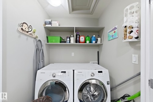 Laundry area featuring built-in shelving, a ceiling-mounted light fixture, and a white door frame - 144 52 Street Sw, Edmonton, AB 