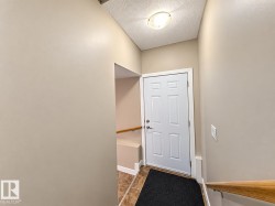 Six-panel entry door, neutral wall finishes, tile flooring, and a flush mount ceiling light fixture - 