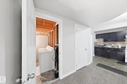 Laundry area with exposed wood framing - 