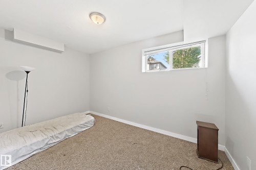 Recessed window with white trim, flush-mount ceiling light, and wall-to-wall carpeting - 144 52 Street Sw, Edmonton, AB 