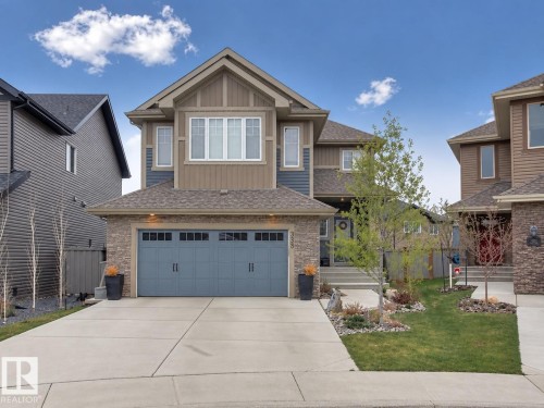 Contemporary exterior with stone accents and horizontal siding - 3329 West Court Nw, Edmonton, AB 