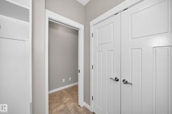 White paneled doors with brushed nickel hardware, tiled flooring, and neutral wall tones - 