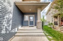 Covered entry with stone-clad pillar, horizontal siding, and concrete steps - 3329 West Court Nw, Edmonton, AB 